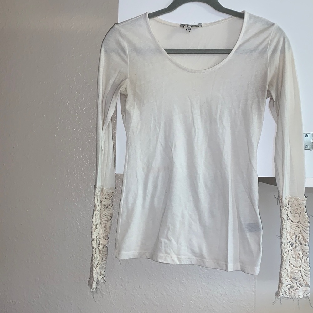 White/cream colored long sleeve shirt with lace detailing on the sleeves